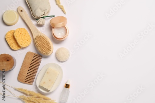 Bath accessories. Different personal care products and dry spikelets on white background, flat lay with space for text