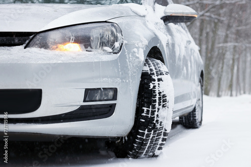 Car with winter tires on snowy road outdoors, closeup © New Africa