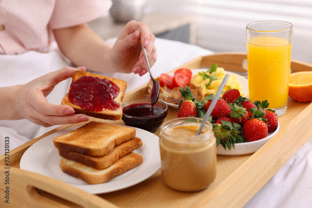 Woman having tasty breakfast in bed, closeup Woman having tasty breakfast in bed, closeup