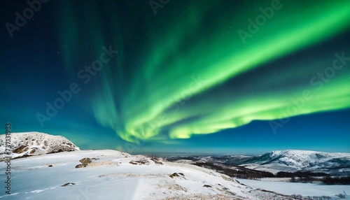 green aurora lights over winter terrain beautiful