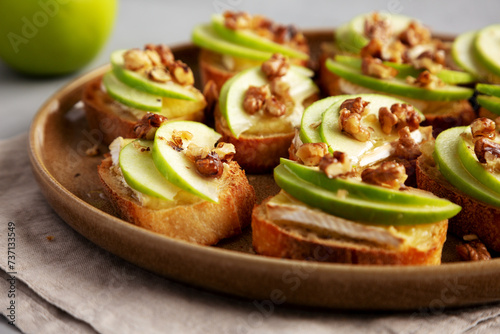 Homemade Apple Brie Crostinis on a Plate, low angle view. Close-up. photo