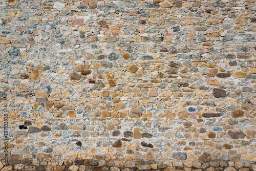 Stone wall background and ancient tuff, Tuscany in Italy