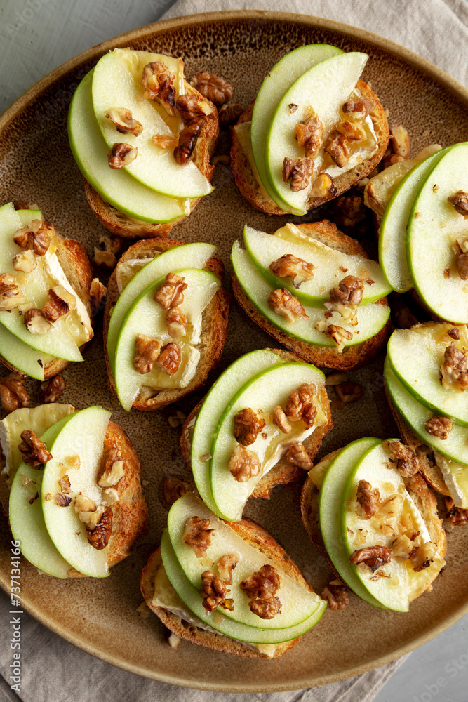 Homemade Apple Brie Crostinis on a Plate, top view. Flat lay, overhead, from above. Homemade Apple Brie Crostinis on a Plate, top view. Flat lay, overhead, from above.