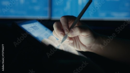 Designer drawing a house layout on a tablet using a pen. Close up, slow motion.