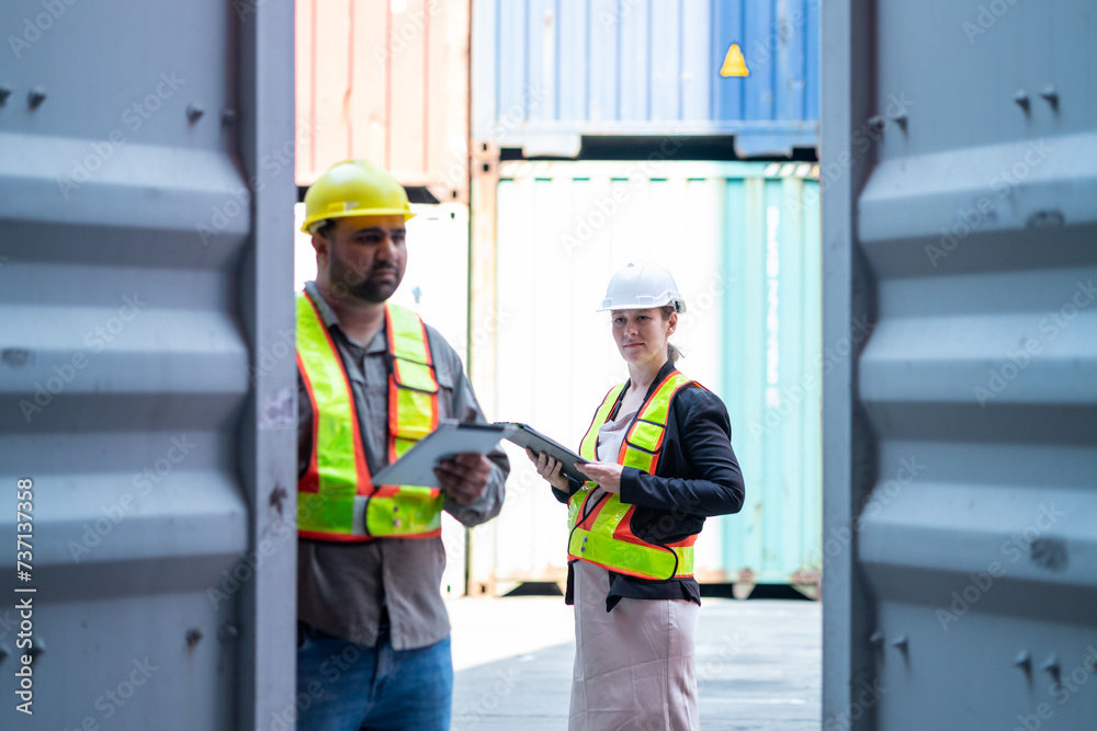 Warehouse engineer inspects the inside of a container with a customer at an industrial container yard. Warehouse engineer inspects the inside of a container with a customer at an industrial container yard.