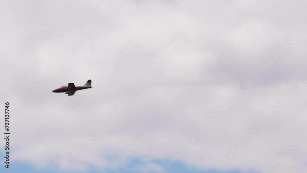Panning Shot Of Aircraft Flying In Blue And White Sky On Sunny Day - Huntington Beach, California Panning Shot Of Aircraft Flying In Blue And White Sky On Sunny Day - Huntington Beach, California