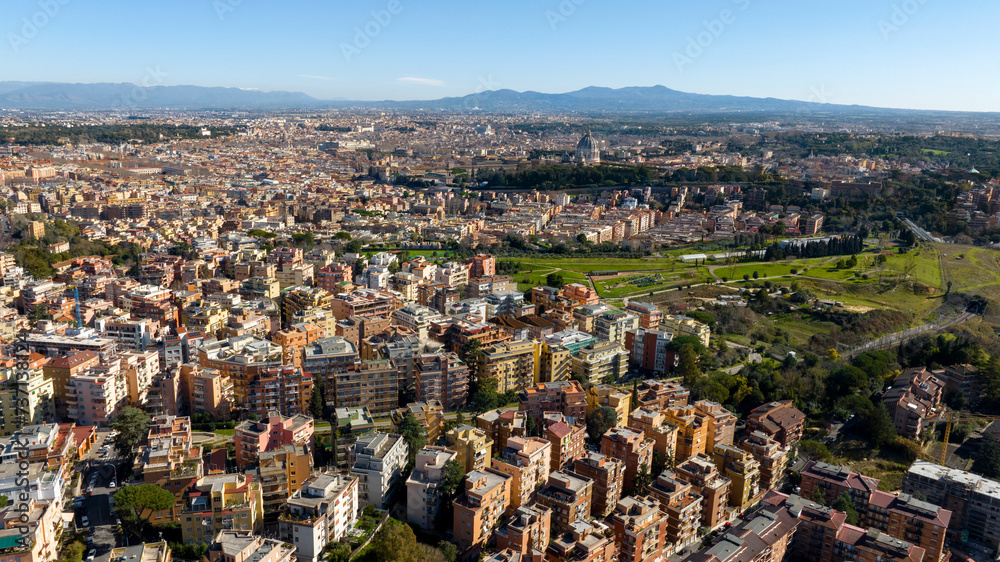 Aerial view of the Balduina neighborhood in Rome, Italy. In the background the dome of St. Peter's Basilica in Vatican City. In the foreground Monte Ciocci and Ettore Scola park.