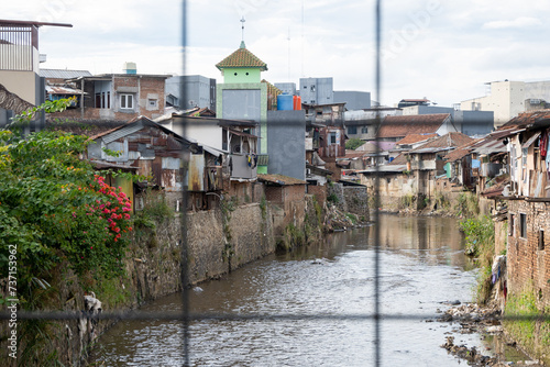 Cikapundung River near densely populated housing on Bandung City, West Java, Indonesia. photo