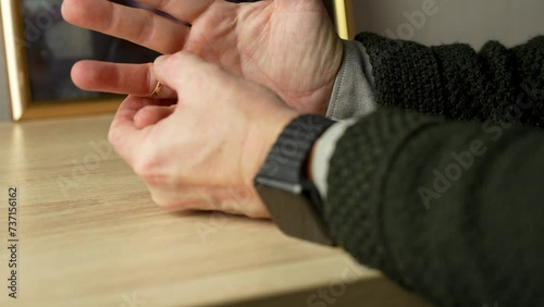 A man taking off wedding ring for separation counselling, cheating or mistake photo