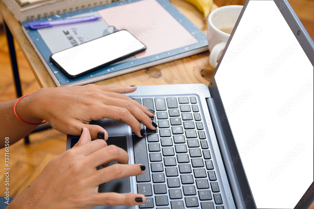 Closeup of female brunette hands of unrecognizable person typing on laptop keyboard on table at home Closeup of female brunette hands of unrecognizable person typing on laptop keyboard on table at home
