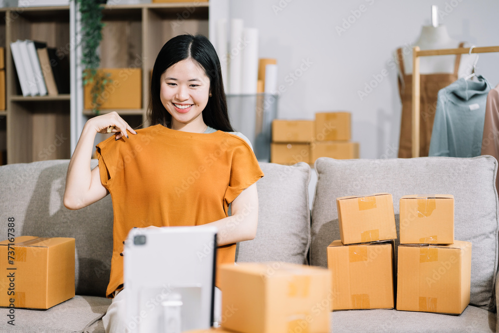 Asian vlogger woman influencer, SME retail store owner smile enjoy selling show live sale online screen smartphone and laptop work at home.. Asian vlogger woman influencer, SME retail store owner smile enjoy selling show live sale online screen smartphone and laptop work at home..