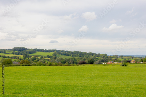 Summer landscape, The terrain hilly countryside in border of Netherlands and Belgium, A small villages and houses on hillside with farmland and forest, Sint-Martens-Voeren, Belgian province of Limburg