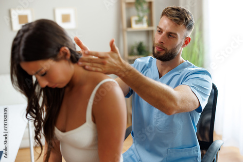 Young woman with neck pain is being examined by a physiatrist