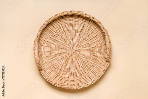 Handwoven Eco-Friendly Tray: Top View of Handcrafted Rattan and Paper Wicker Serving Tray on Beige Surface
