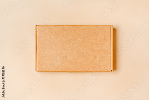 Eco-Friendly Packaging: Top View of Cardboard Box on Beige Background © Iana Alter