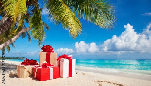 christmas presents gifts on tropical beach under palm tree