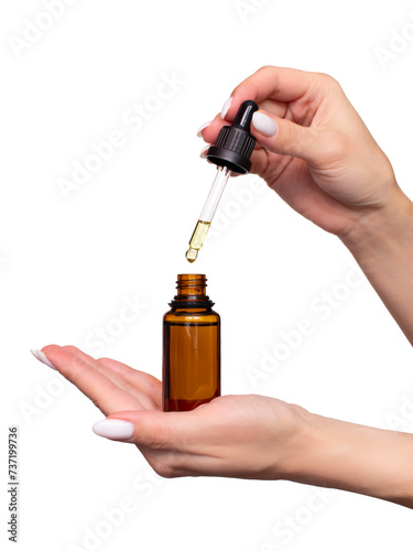 A woman holds a dark glass bottle in her hands and drops oil or serum. Isolated on white background. A dropper with a yellow cosmetic product for the skin, face, hair or body. Self care and beauty