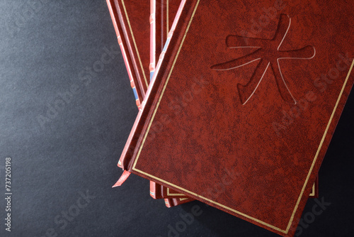 Stack of books with engraved symbol confucianism top view
