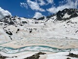 Snow, mountain lake and Presena glacier in italy