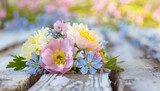 Colorful spring flowers on rustic light wooden planks with copy space for text. Celebration concept