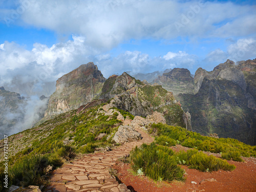 Beautiful mountain hiking trail from Pico do Arieiro to Pico Ruivo. Rocks and cloudy sky in Madeira island, Portugal photo
