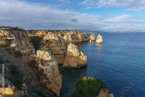 Famous rock formation of cliff in golden sunlight at the atlantic coast line near Ponta da Piedade, Lagos, Algarve, Portugal.