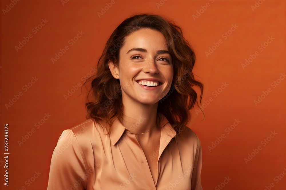 Portrait of happy young woman looking at camera over orange background. Portrait of happy young woman looking at camera over orange background.
