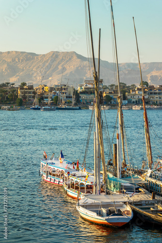 Colorful motorboats and feluccas on the bank of the Nile in Luxor, Egypt