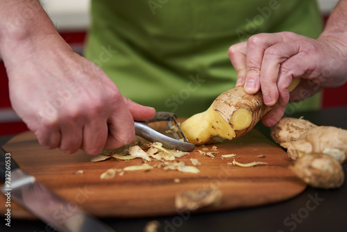 Cook peeling and cleaning ginger