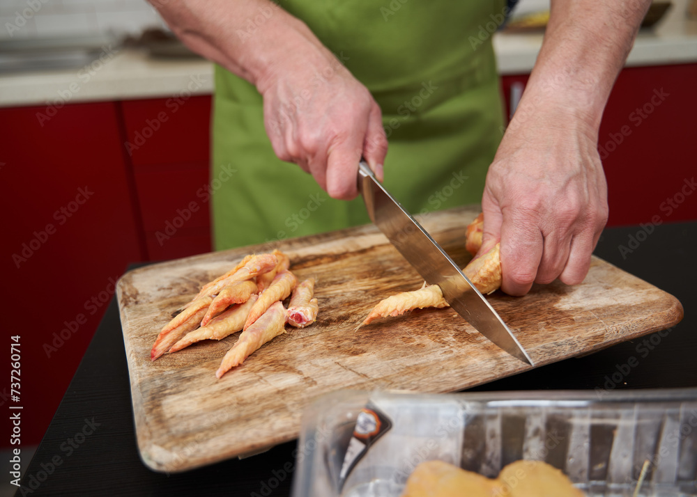 Man cook cutting chicken wings Man cook cutting chicken wings
