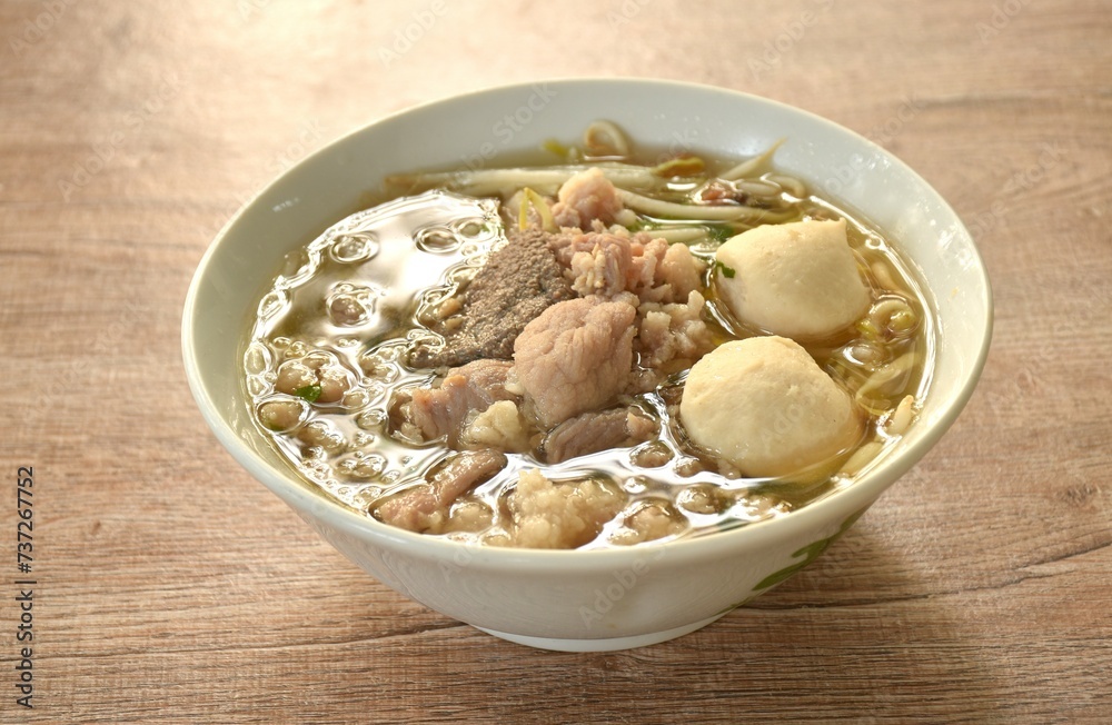 boiled slice soft and chop pork and meatball in clear soup on bowl boiled slice soft and chop pork and meatball in clear soup on bowl
