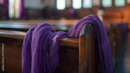 sacred purple blanket on a chair in a daytime church with a cross