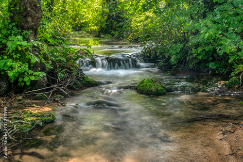 Turquoise color of water in the summer on the river Janj