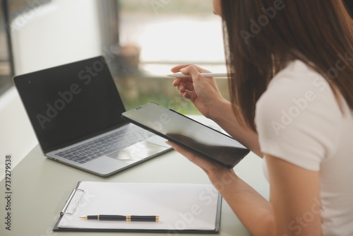 Asian businesswoman working on laptop computer Look for job online  freelance looking and typing on notebook on table  lifestyle of woman studying online