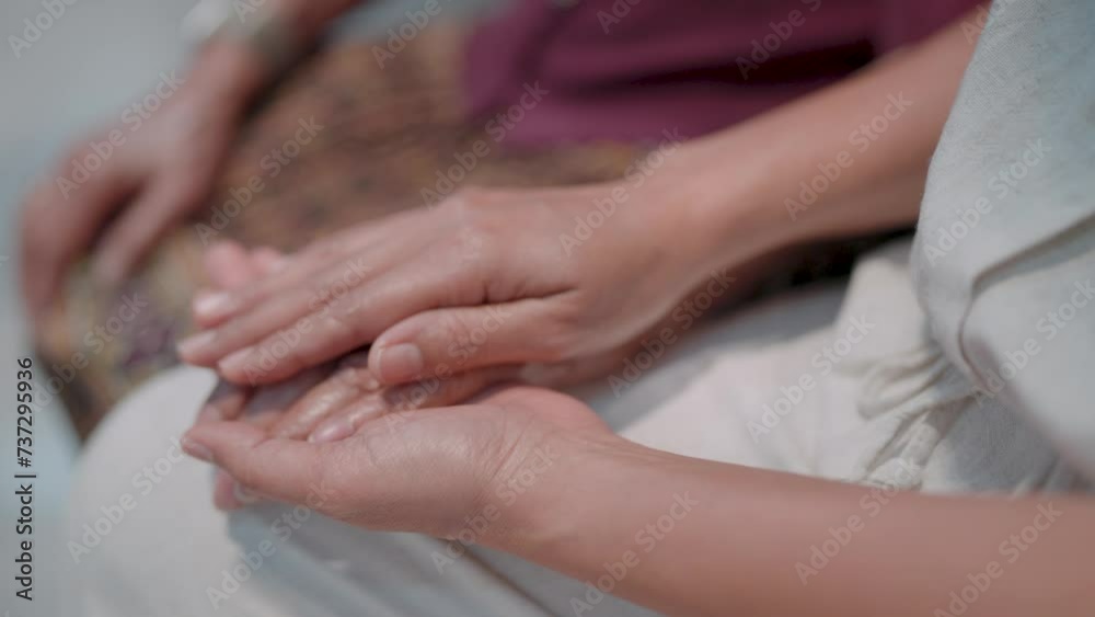 Mature young woman's daughter holds hands with older female mother-in-law while two women support the concept of giving love to caring for the elderly, helping parents. Mature young woman's daughter holds hands with older female mother-in-law while two women support the concept of giving love to caring for the elderly, helping parents.