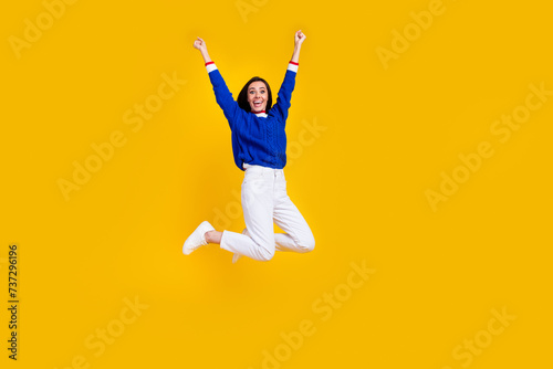 Full length photo of overjoyed lady raised fists up triumphant end her master graduation in university isolated on yellow color background
