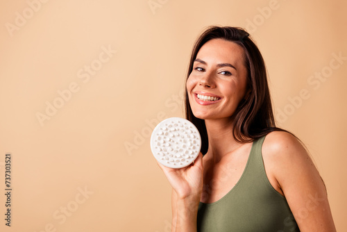 No retouch photo of gorgeous adorable woman hold brush dry anti cellulite massage procedure empty space isolated on beige color background