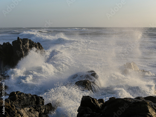 Small cape being hit by strong stormy sea waves
