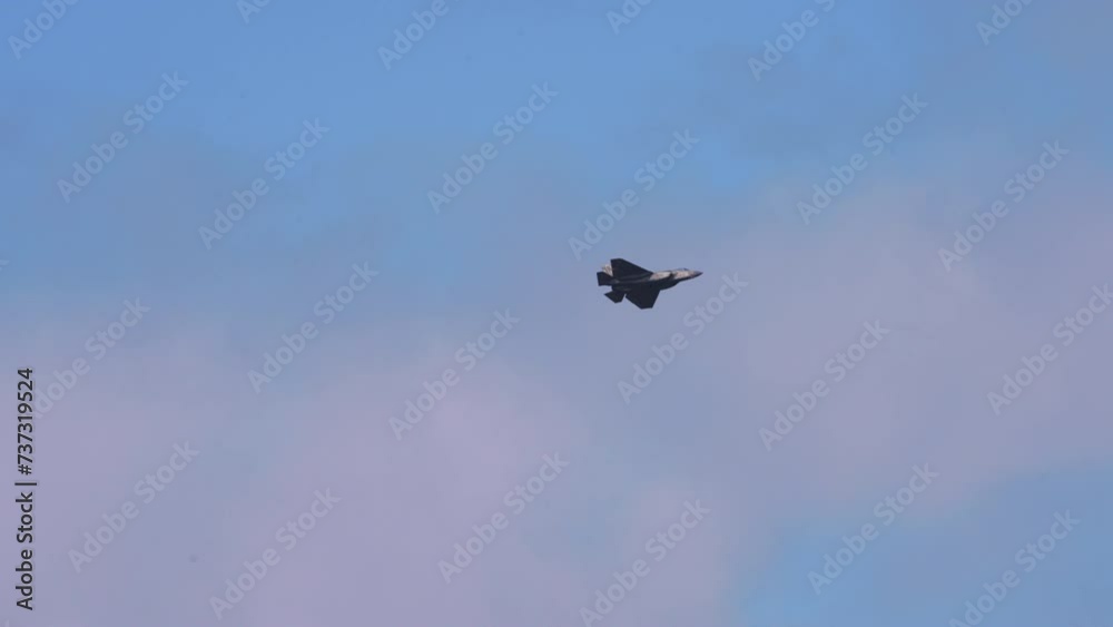 Panning Shot Of Aerobatic Plane Flying In Cloudy Sky On Sunny Day - Huntington Beach, California Panning Shot Of Aerobatic Plane Flying In Cloudy Sky On Sunny Day - Huntington Beach, California