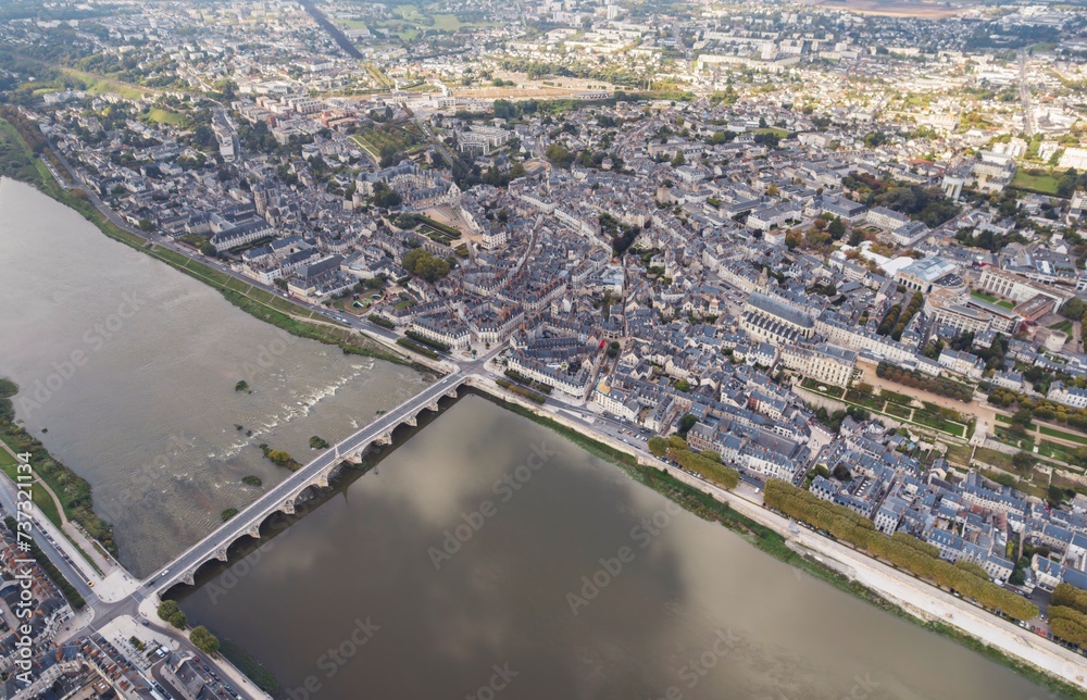 Fototapeta premium Riverside Tapestry: An Aerial Symphony of Blois, Loir-et-Cher, and the Majestic Val De Loire