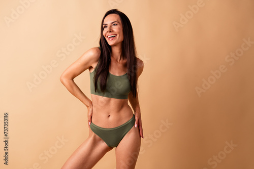 Photo portrait of attractive young woman touch waist pretty model no retouch wear trendy khaki lingerie isolated on beige color background