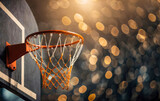 Close-up of a basketball court hoop with orange bokeh lights in the background.
