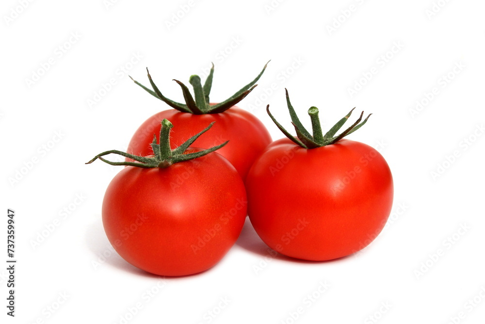 Three red tomatoes lie on a white background.	