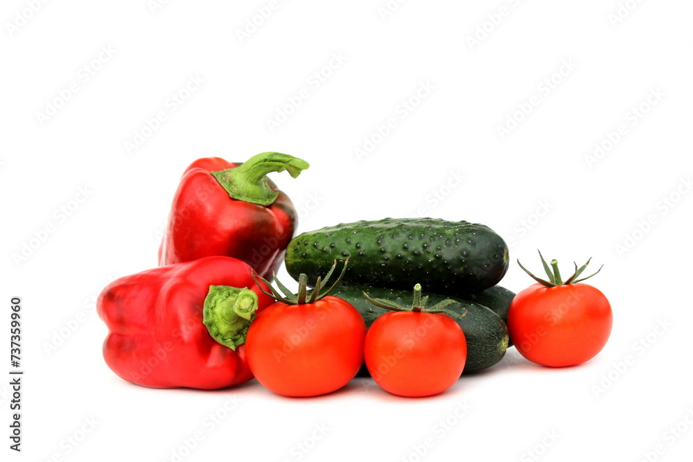  Cucumbers and tomatoes in one pile lie on a white background.