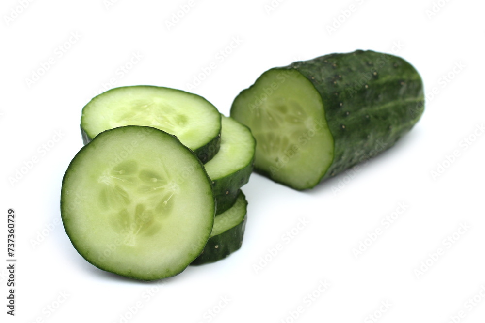 Many pieces of sliced cucumber lie on a white background. Many pieces of sliced cucumber lie on a white background.