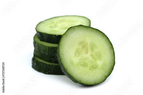 A bunch of sliced cucumbers in circles lie in one pile.	