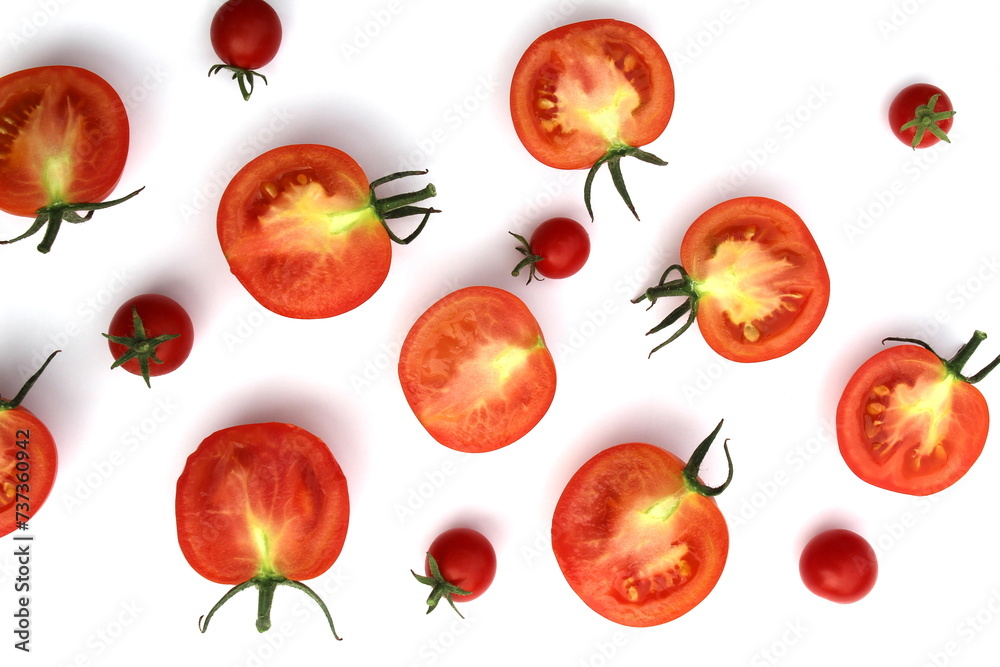 Tomatoes cut in half lie on a white background. Tomatoes cut in half lie on a white background.