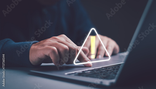 Fototapeta Naklejka Na Ścianę i Meble -  user works with laptop computer that has an error warning triangle sign. concept of a warning or notification Computer virus detection Data protection network security system cyber security system