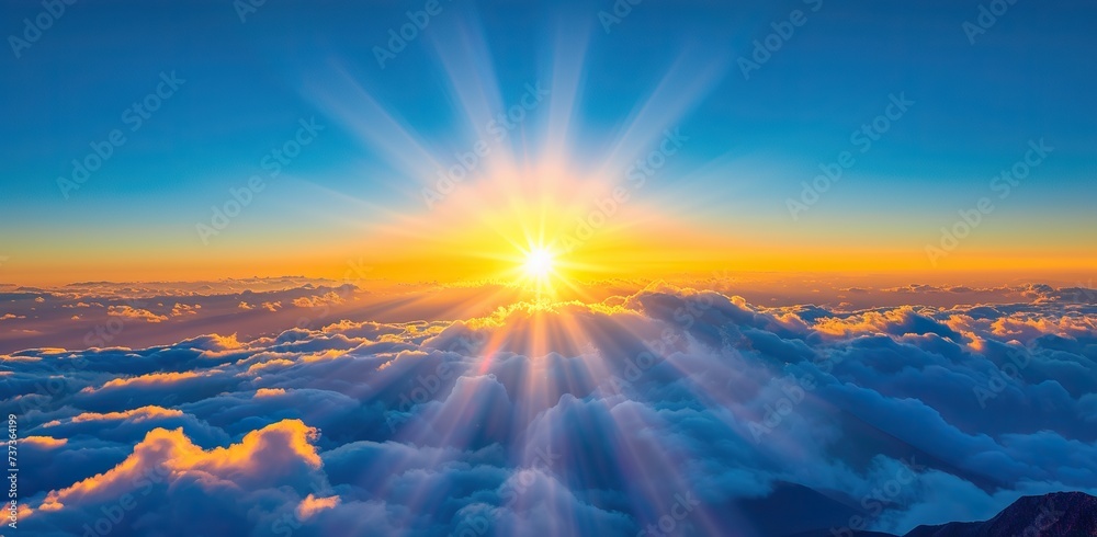 Sunrise above the clouds with sunbeams. The concept of hope and a new beginning.