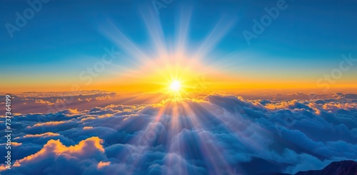 Sunrise above the clouds with sunbeams. The concept of hope and a new beginning. © volga